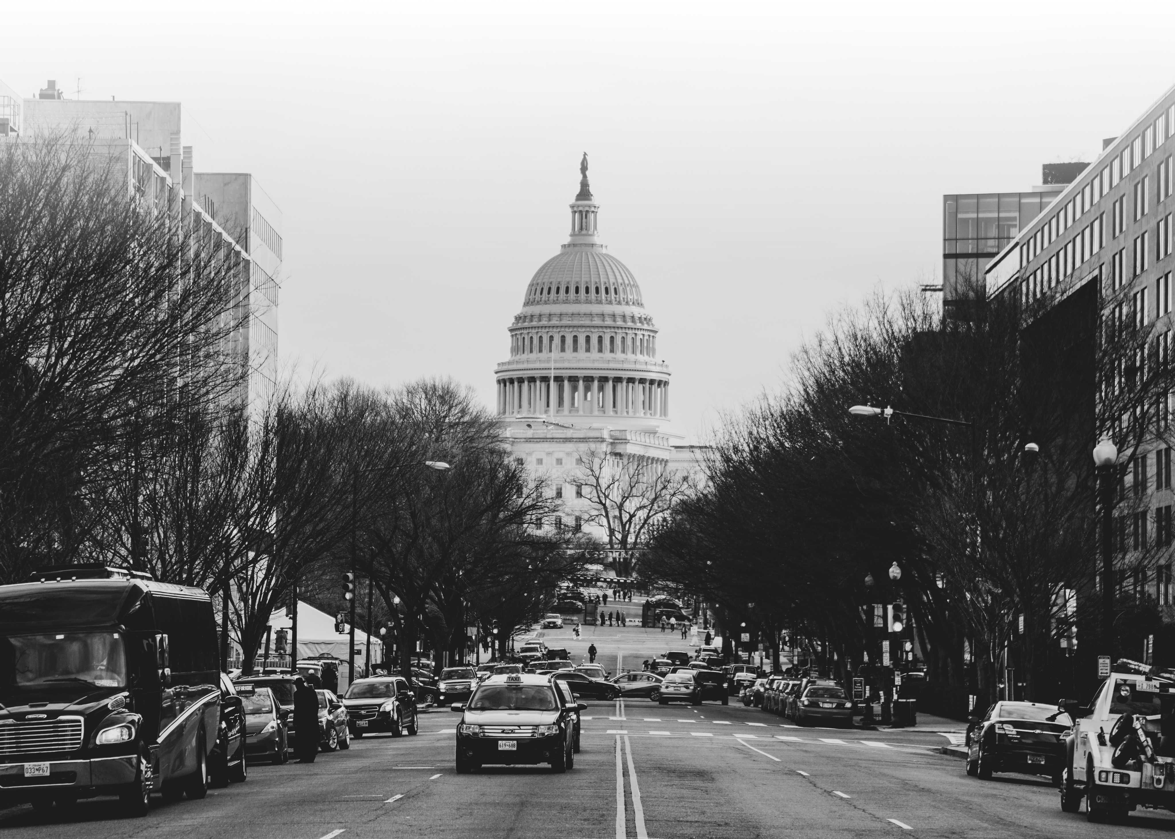 Washington, D.C. Capitol building as seen from a distance, standing on a street.